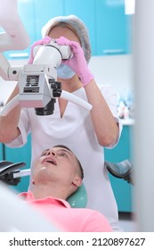 Dental Treatment Under A Microscope. Professional Examination At The Dentist. A Man At A Dentist's Appointment. Modern Dentistry.