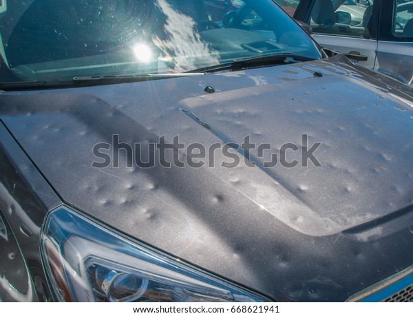 Dented car after a big hail\
storm