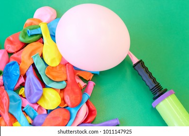 Dented Colored Balloons And Pump.