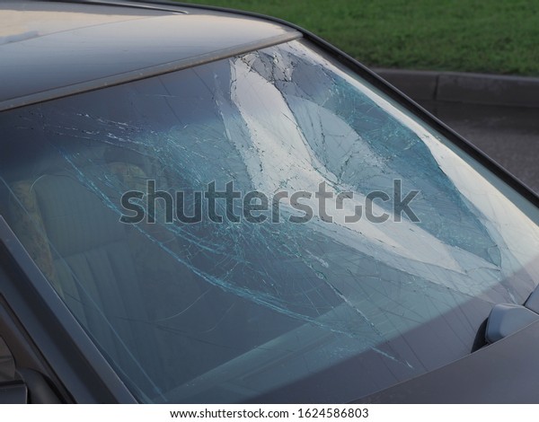 Dented inside the cabin broken glass\
dark passenger car after hitting a person,\
pedestrian