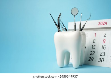 Dentist appointment calendar on a blue background with copy space. Reminder calendar for visiting dental clinic. Dentistry check up date