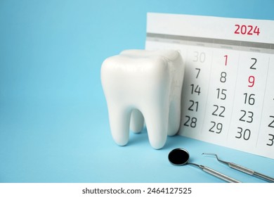 Dentist appointment calendar on a blue background with copy space. Reminder calendar for visiting dental clinic. Dentistry check up date