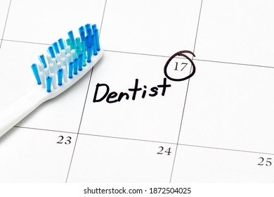 Dentist appointment reminder on calendar with toothbrush. Concept of oral health, exam and teeth cleaning - Powered by Shutterstock