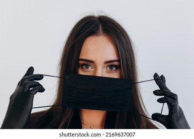 Dentist In Black Coat And Protective Black Mask Against Covid