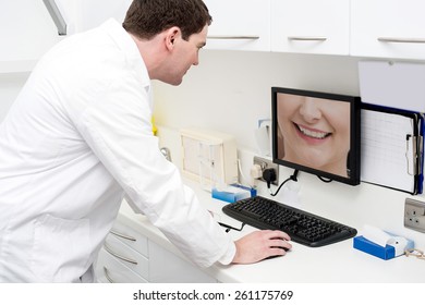 Dentist Checking Patient Teeth In Computer Screen