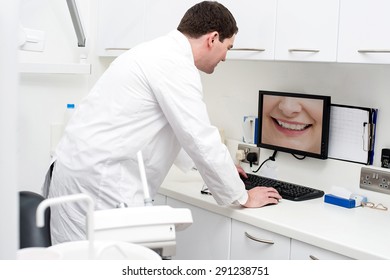 Dentist Checking Patient Teeth In Computer Screen