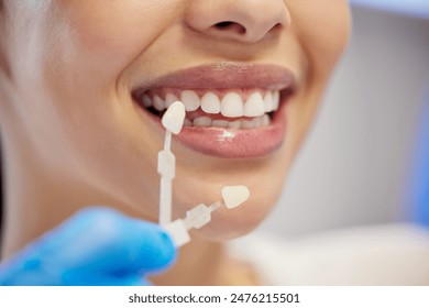 Dentist, cleaning and dental procedure for toothache in clinic, health and treatment for mouth. Teeth whitening, face and person with torque wrench machine, orthodontics and oral care for veneers - Powered by Shutterstock