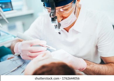 Dentist cleans tooth canals of patient and removes nerve - pulpitis treatment - Shutterstock ID 1762644056