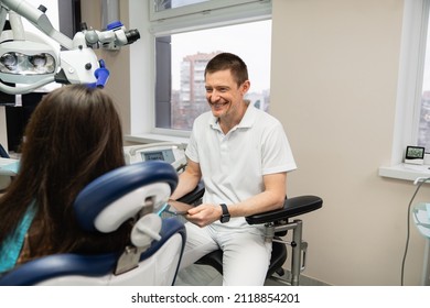 Dentist Communicates With Patient In Dental Office Using Digital Tablet