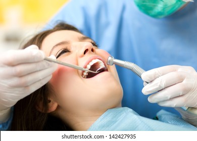 Dentist Curing A Female Patient 