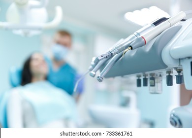 Dentist curing a female patient in the stomatology. Treatment concept. - Shutterstock ID 733361761