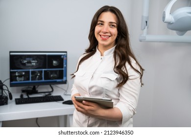 Dentist With Digital Tablet In Dental Office