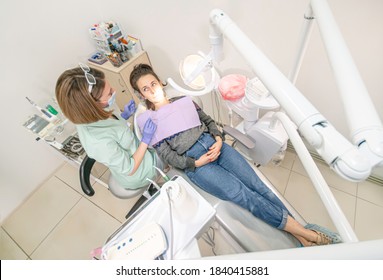 Dentist Doctor Examines The Patient On The Dental Chair. View Above.