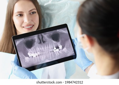 Dentist Doctor Examines X-ray Of Female Patient Jaw