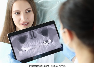 Dentist Doctor Holding Digital Tablet With Teeth Xray In Front Of Patient