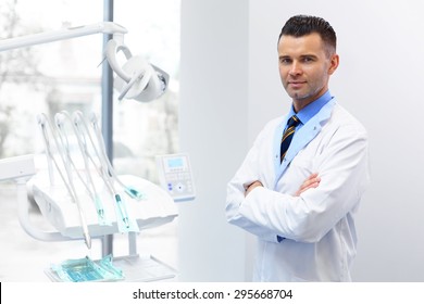 Dentist Doctor Portrait. Young Man At His Workplace. Dental Clinic