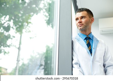 Dentist Doctor Stands Near Window and Thinks about Clinic Future
