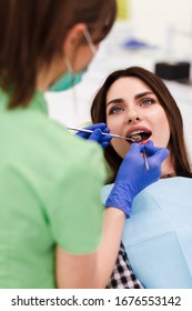 Dentist Does An Oral Examination. Pretty Patient Woman Came To The Dentist's Appointment