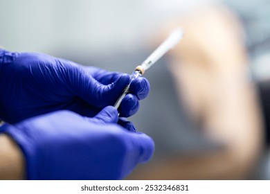 A dentist is drawing an anesthetic into a syringe, close-up. - Powered by Shutterstock