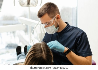 the dentist examines the patient's oral cavity - Shutterstock ID 2124435710