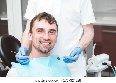 Dentist Examines The Teeth Of A Male Patient On A Dentist's Chair. Copy, Empty Space For Text