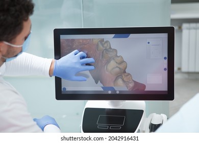 Dentist Examining Dental Scan Of A Patient On The Computer Screen