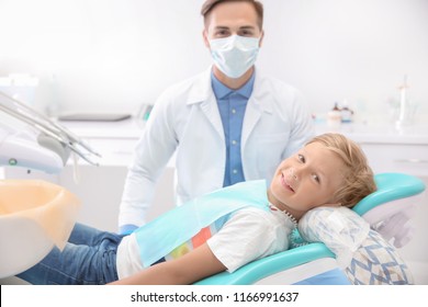 Dentist examining little boy's teeth in clinic - Shutterstock ID 1166991637
