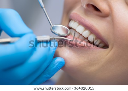 Dentist examining a patient's teeth in the dentist.