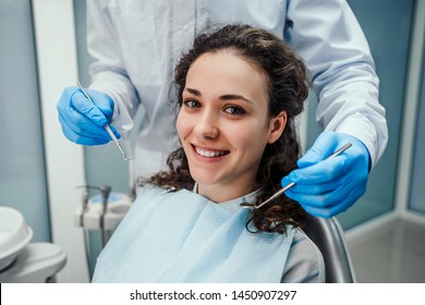 Dentist examining a patient's teeth in the dentist chair. Healthcare and medicine concept. - Powered by Shutterstock