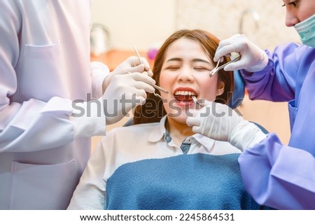 Dentist examining teeth patients in clinic for better dental health and a bright smile.Dentist is extracting wisdom teeth.Dentist tools and equipment.