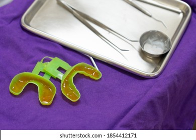 Dentist Filling Fluoride Into Mouth Guard To Do Treatment For Kid At Dental Clinic