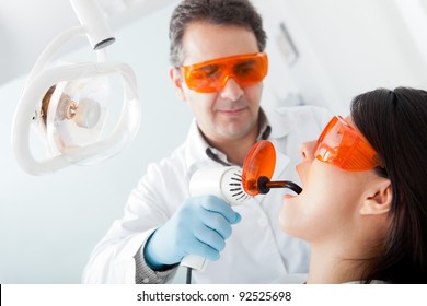 Dentist Fixing A Cavity On A Female Patient Using Laser