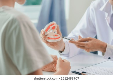 Dentist gives interesting advice about dental health, young man, focusing on oral health and dental care, dental or dental health concept. - Powered by Shutterstock