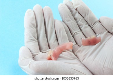 Dentist Hand Wear Medical Rubber Glove With Broken Plastic Dentures.