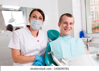 The dentist and her happy patient look at the camera and smile. Reception at the dentist, healthy teeth, happy patient, beautiful teeth. - Shutterstock ID 1438390781
