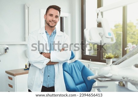 Dentist in his office, dental care, professional young doctor