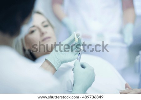 Dentist holding syringe