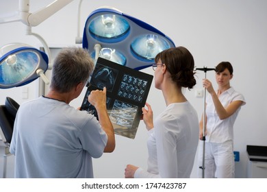 Dentist and hygienist reviewing x-ray - Powered by Shutterstock