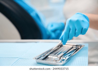 Dentist hygienist at workplace uses sterile instruments - Powered by Shutterstock