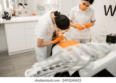 The dentist injects the patient's tooth gum using a syringe. Modern medical equipment. - Powered by Shutterstock