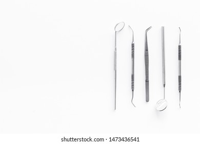 Dentist Instruments On White Doctor's Office Desk Background Top View Mock-up