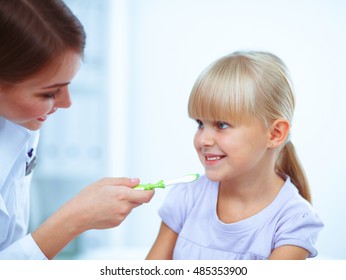 Dentist and little girl in the dentist office.  - Shutterstock ID 485353900