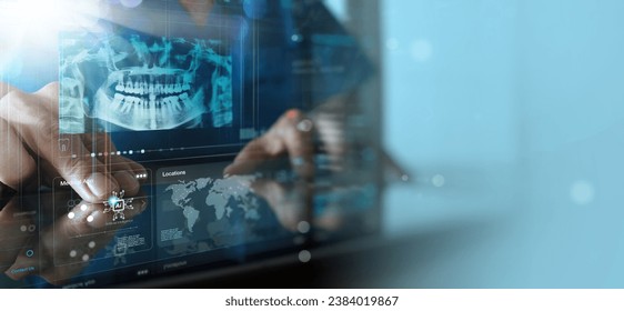 Dentist looking on the virtual Ai x-ray of a jaw working with a computer in the dental office.