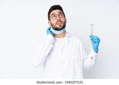 Dentist man holding tools isolated on white background thinking an idea