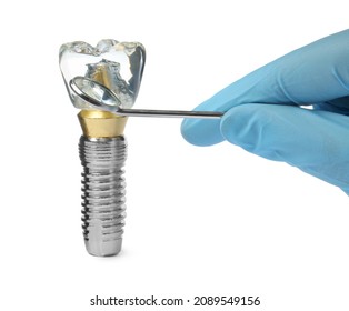 Dentist with mirror pointing at educational model of dental implant on white background, closeup - Shutterstock ID 2089549156