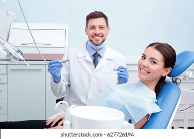 Dentist With Patient In Clinic