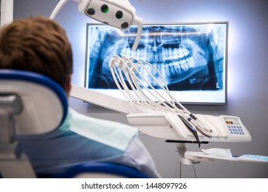 Dentist patient looking at a dental x-ray image