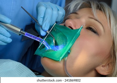 Dentist With Patient, Using Dental Curing Light