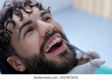 Dentist performing examination with specialized tools during routine dental checkup - Powered by Shutterstock