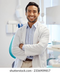 Dentist, portrait and man with arms crossed for healthcare service, dental hospital or insurance in consultation office. Happy asian person or doctor with teeth, oral or hygiene health in clinic